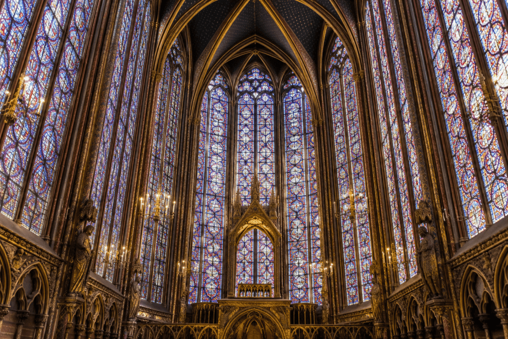 Hautes verrières colorées et voûtes gothiques dans la chapelle haute de la Sainte-Chapelle.